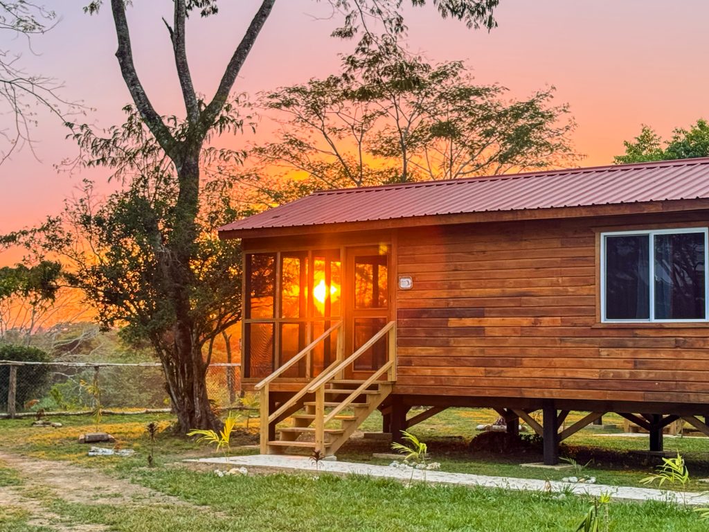 Sunset view from the screened verandah of a cabin at Cahal Pech Cabins in Carmelita, Belize.